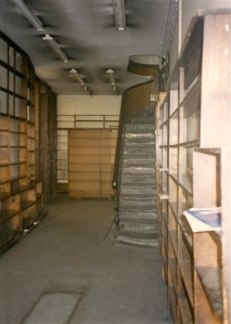 The narrow interior of the shop after its sale. The stairs led to the rooms where books were sorted for libraries.